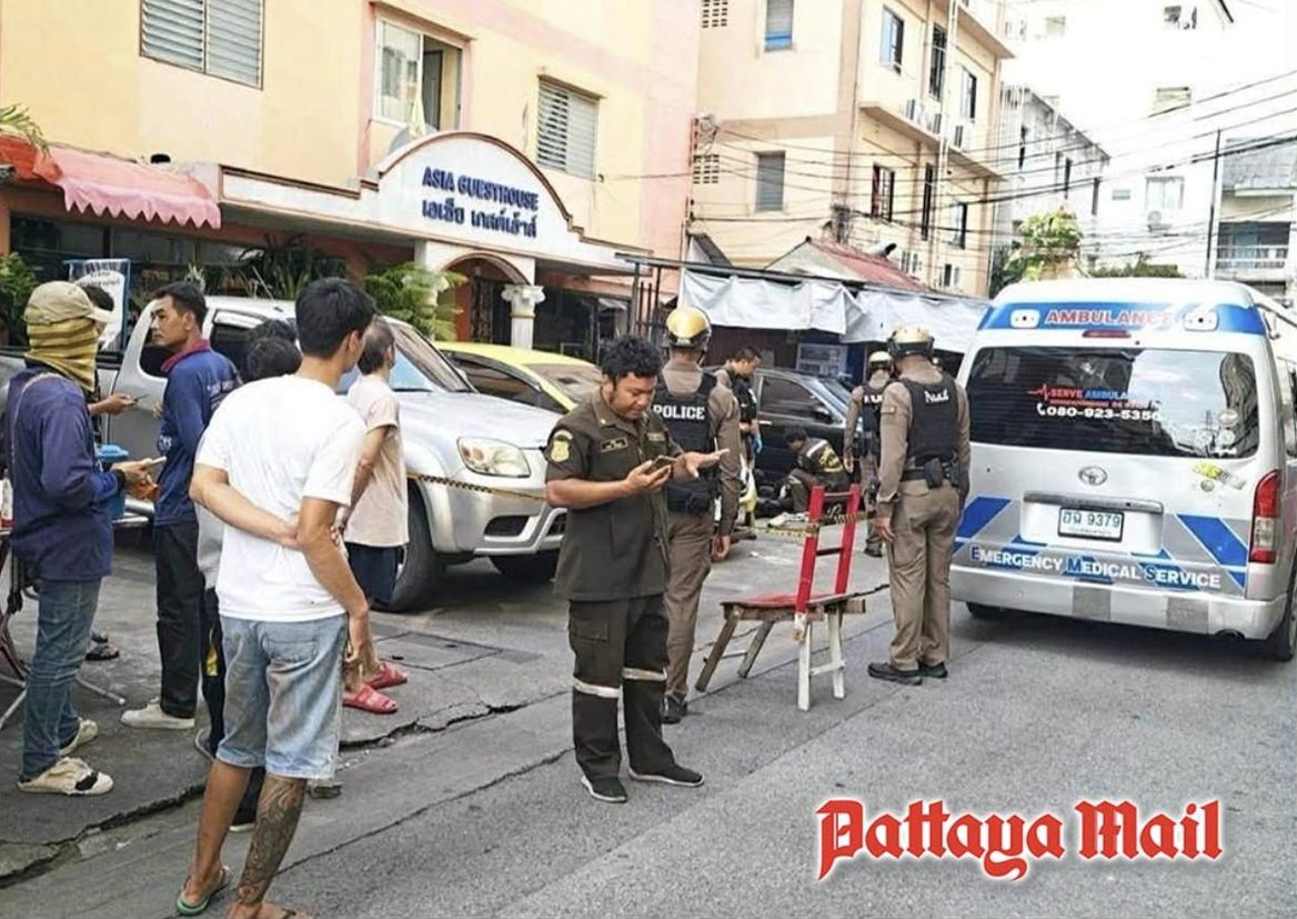Police officers and an ambulance outside an apartment building in Soi Phatthanakan 43, Suan Luang, Bangkok
