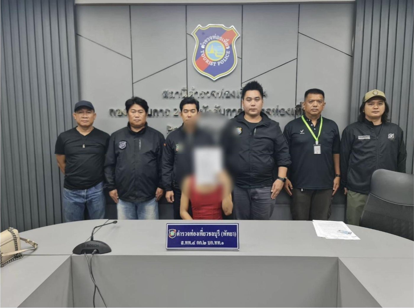 Chonburi tourist police officers presenting a robbery suspect at the Pattaya tourist police station in Thailand