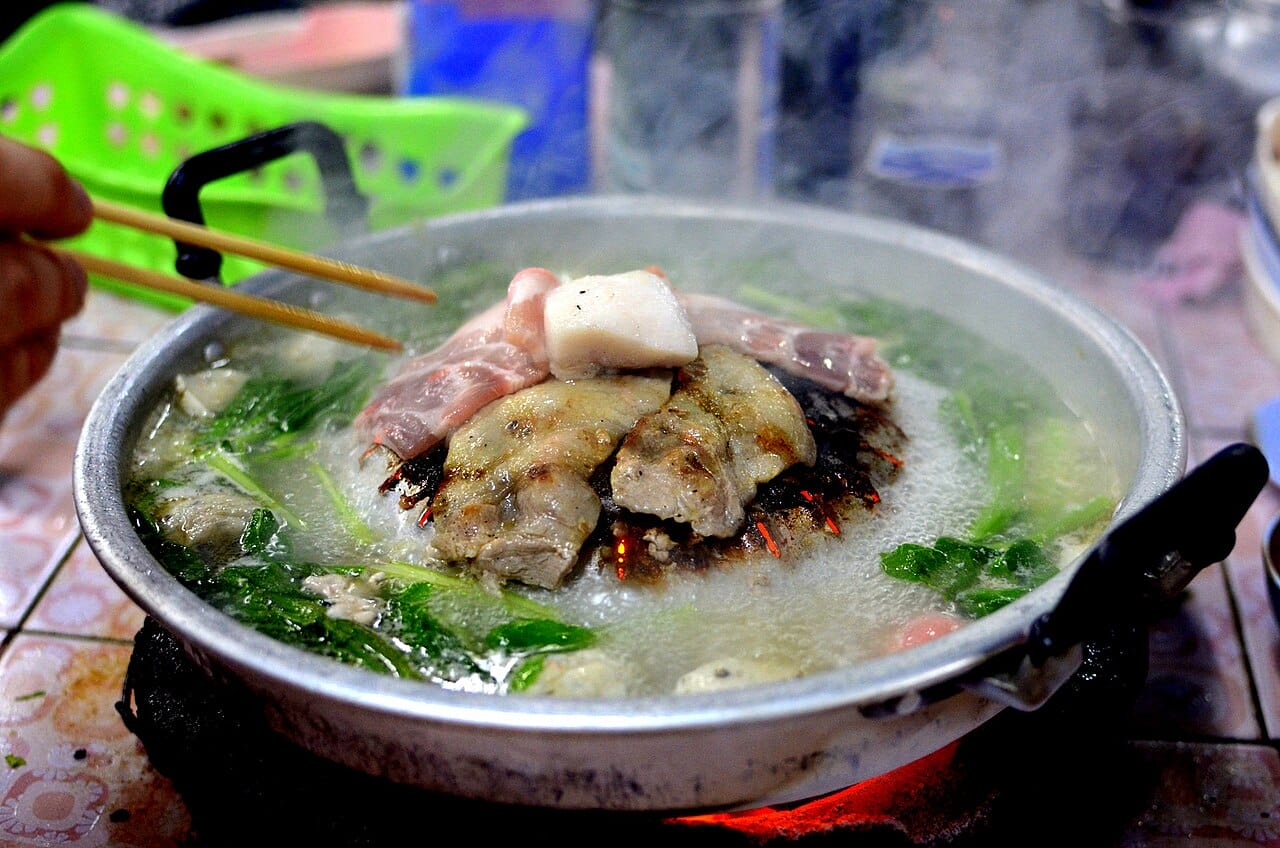 Moo gata — Thai barbecue hot pot with grill dome and surrounding broth