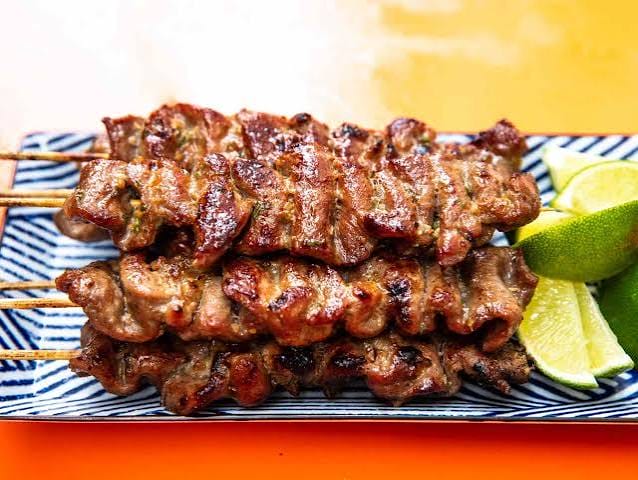 Moo ping — grilled marinated pork skewers over charcoal