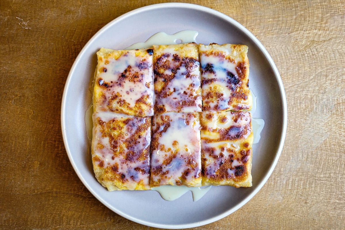 Roti gluay — crispy banana pancake drizzled with condensed milk and chocolate