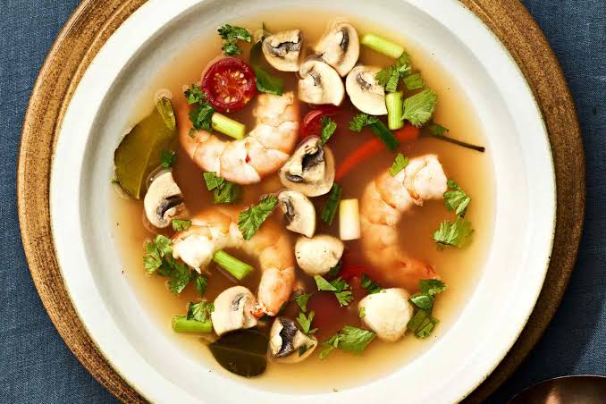 A steaming bowl of tom yum goong with prawns, lemongrass and chilli