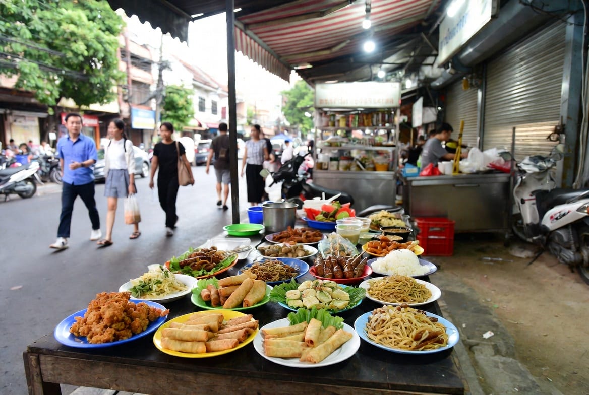Plates of familiar Thai street dishes displayed at a Sukhumvit 38 stall