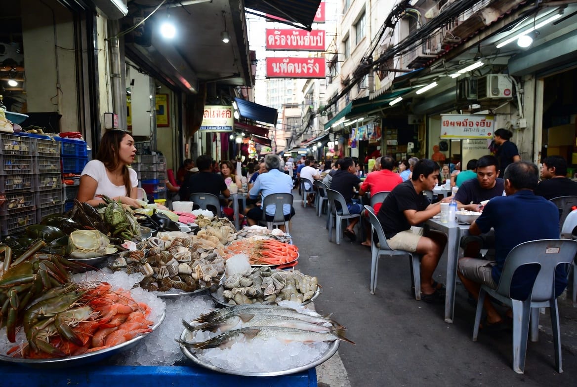 Fresh seafood and prepared dishes on display at the Silom Soi 20 morning market