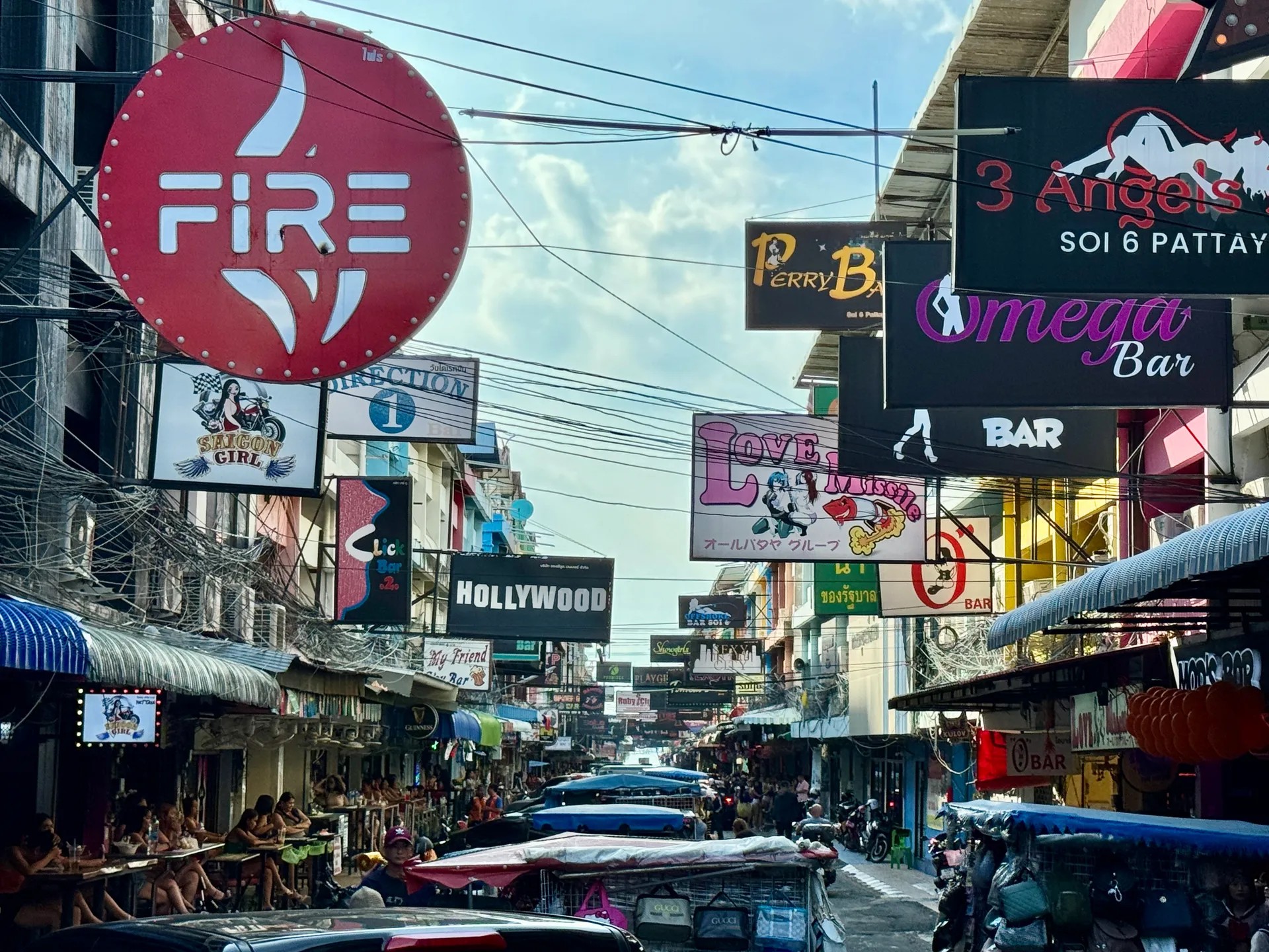 Soi 6 bar signs over a quiet daytime street